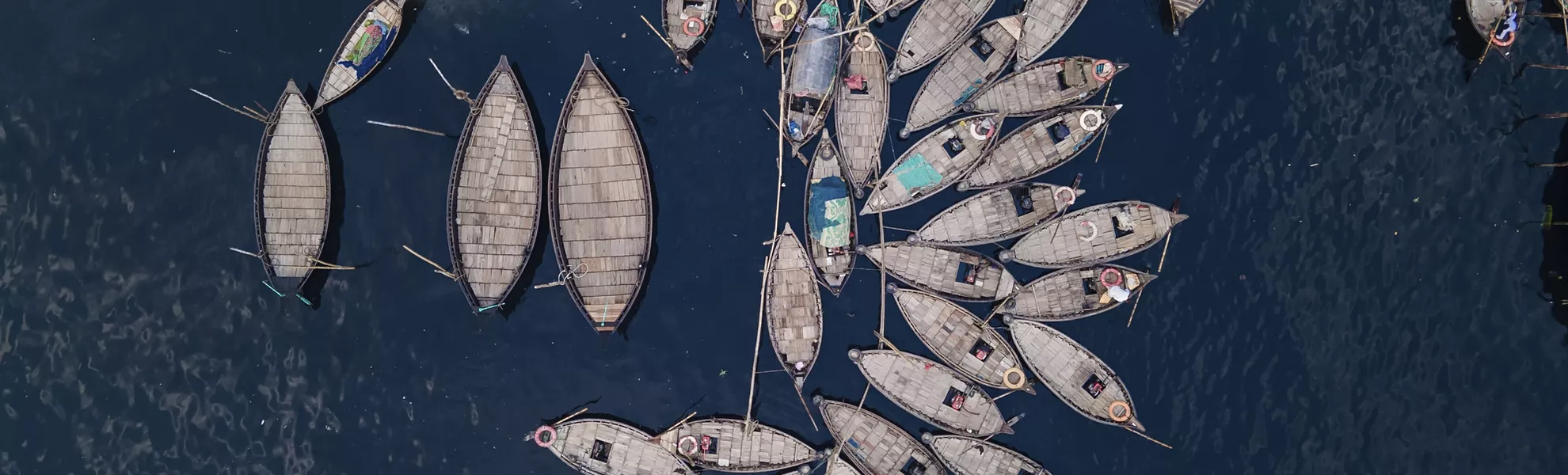 Aerial view of Wooden passenger boats along the Buriganga River, Sadarghat, Dhaka, Bangladesh - © Muhammadamdadphoto - stock.adobe.com